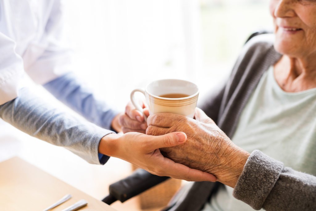 carer with cup of tea