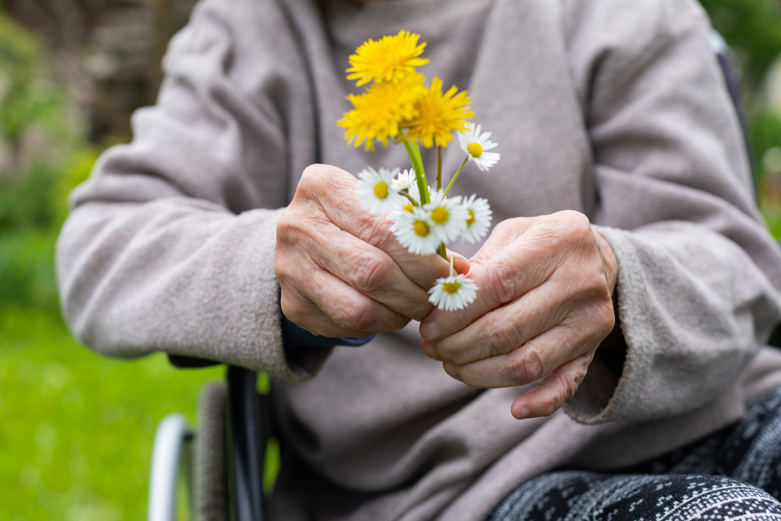 person with dementia holding flowers